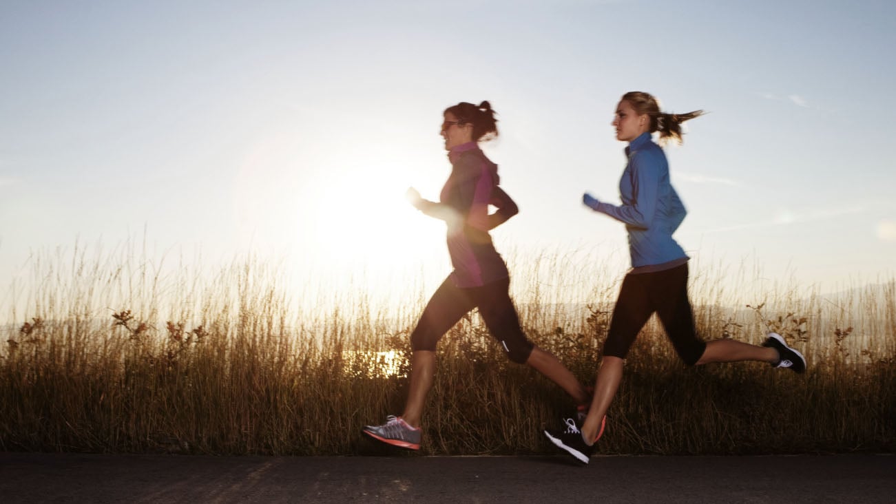 Two women jogging together outside