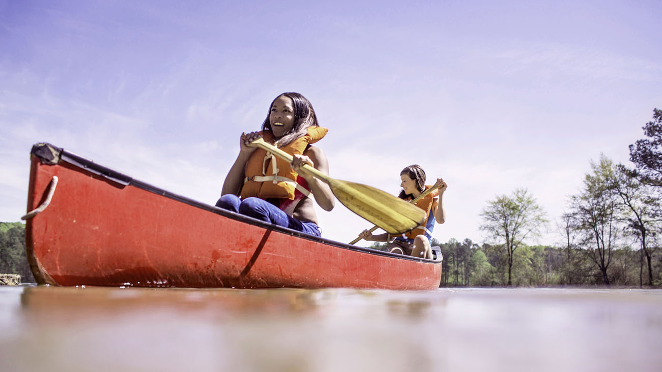 Two women kayaking together on a lake