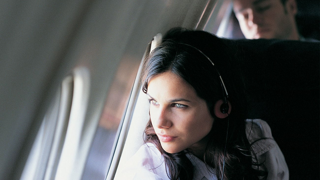 Woman on an airplane looking out the window