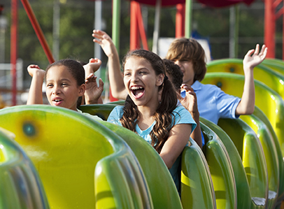 Children on a rollercoaster at an amusement park